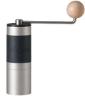 A manual coffee grinder with a brushed silver metal body, a black grip band, and a light wood crank handle, shown against a gray checkerboard transparency background. KINGrinder K2