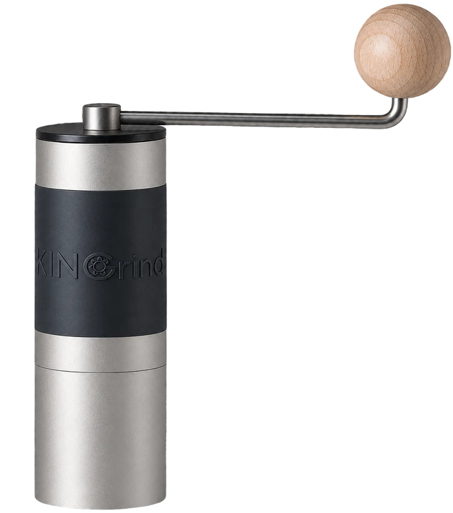 A manual coffee grinder with a brushed silver metal body, a black grip band, and a light wood crank handle, shown against a gray checkerboard transparency background. KINGrinder K2